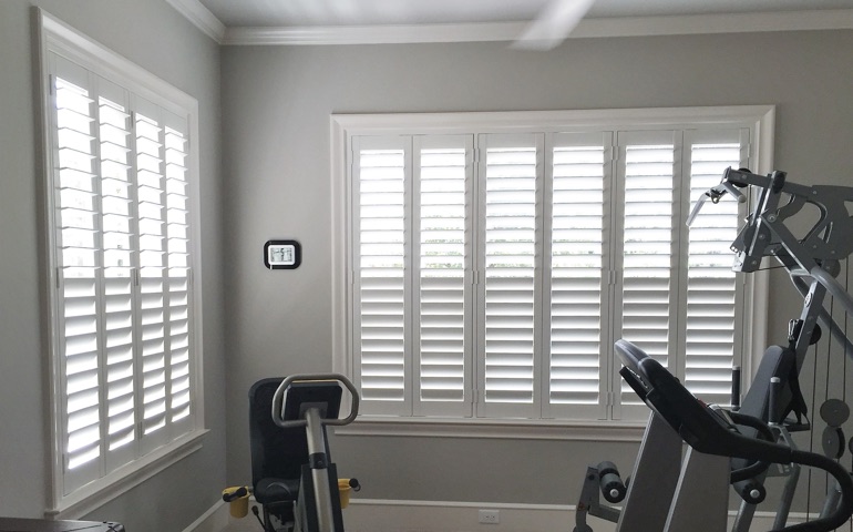 Charlotte fitness room with shuttered windows.